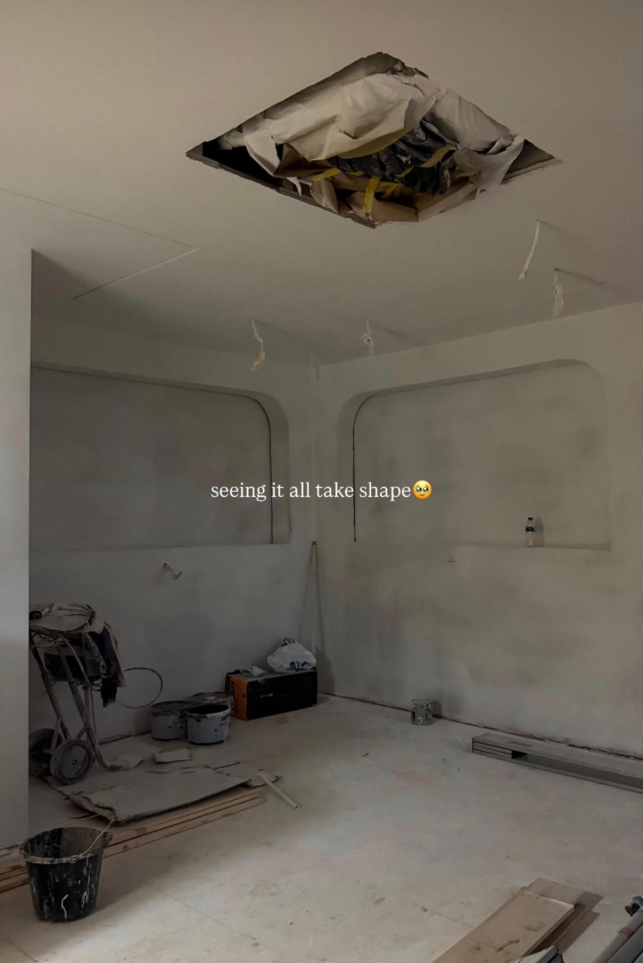 Freshly plastered walls and a ceiling being patched during the fit-out