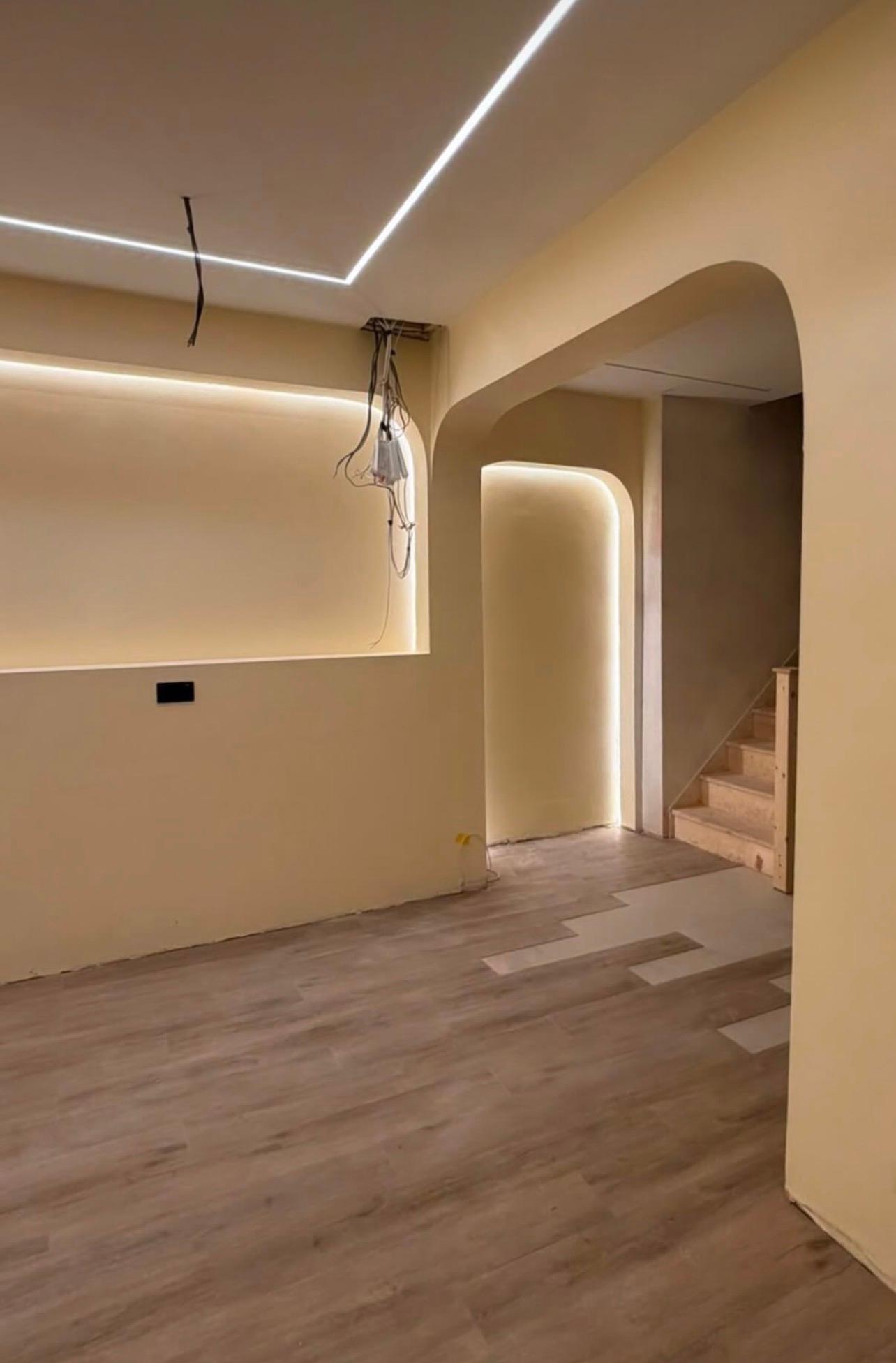 Warm LED-lit arches and a staircase inside the developing café