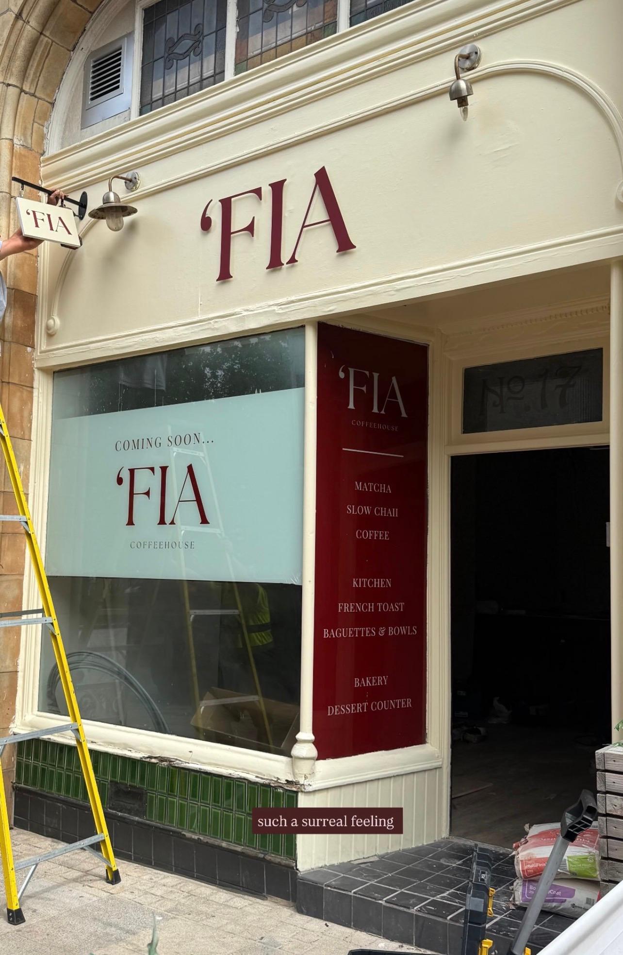 Daytime shopfront with "Coming Soon 'FIA" window signage and a menu preview